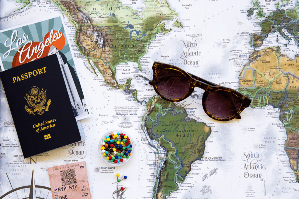 Passport and sunglasses on top of a map