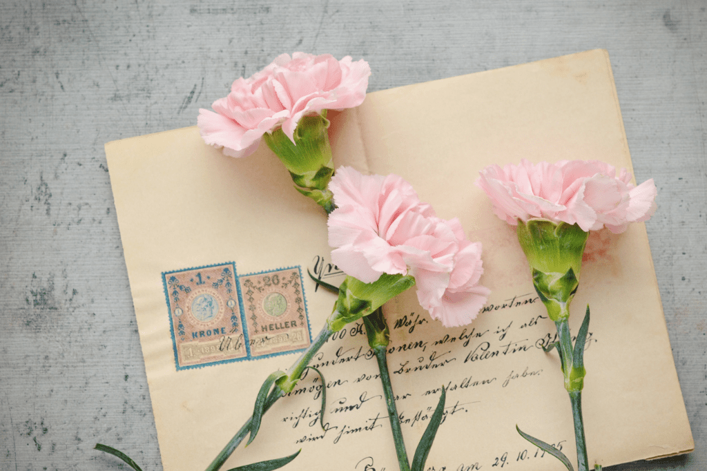 A letter with pink flowers laid on top