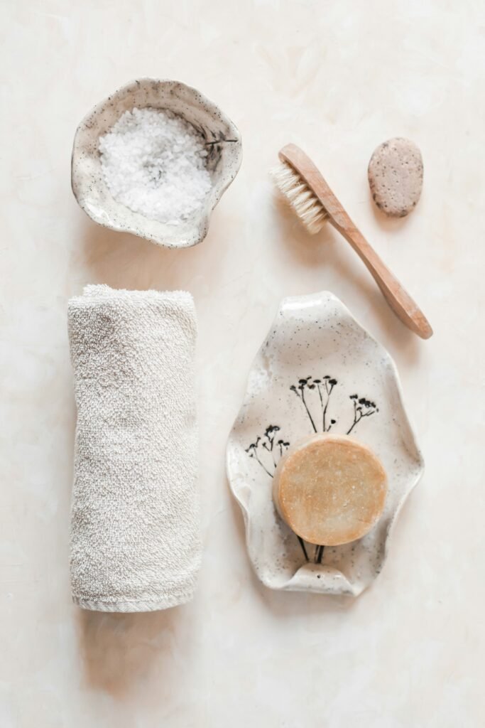 A towel, exfoliating brush, soap, and Epsom salt.
 